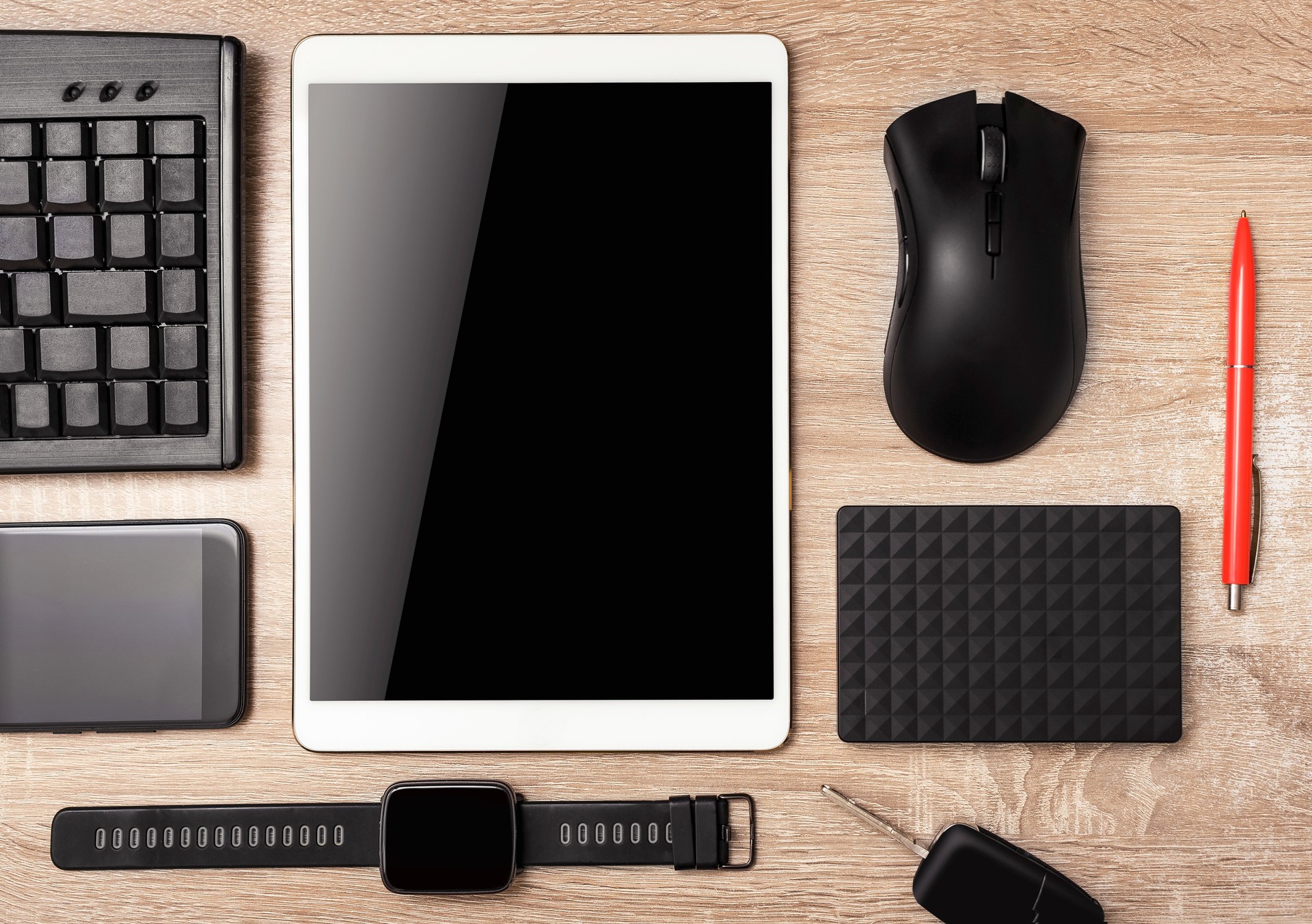Tablet computer, smartphone, keyboard, smart watches, computer mouse on the wooden table